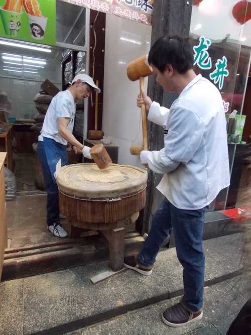 Workers smashing grains